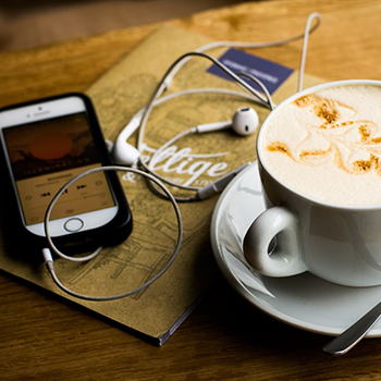 Phone, headphones and cup of coffee
