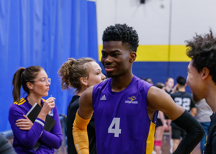 Volleyball player standing with teammates