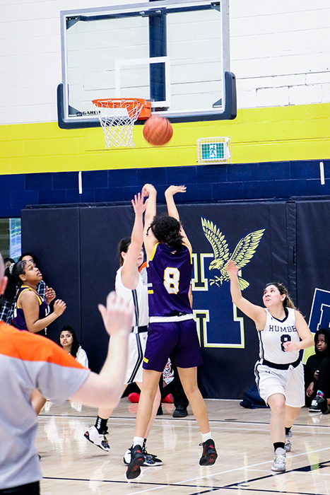 basketball player throwing ball during game