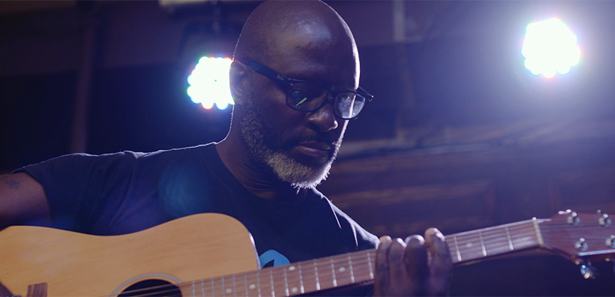 Carlos Morgan playing guitar