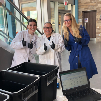 Three women wearing lab coats