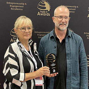 Spotlight story image pertaining to Ulrike Gross, AVP: Facilities and Asset Management, and Jonathan Newman, VP: Research, pose at the Triple E Awards in Barcelona, Spain