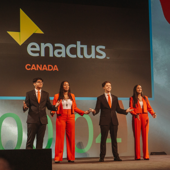 Four people standing on a stage.