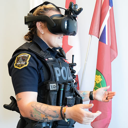 Police officer wearing virtual reality headset doing mental health crisis response training