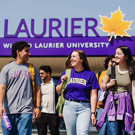 Laurier Milton students in front of Laurier sign