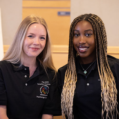 Community Psychology students working at conference