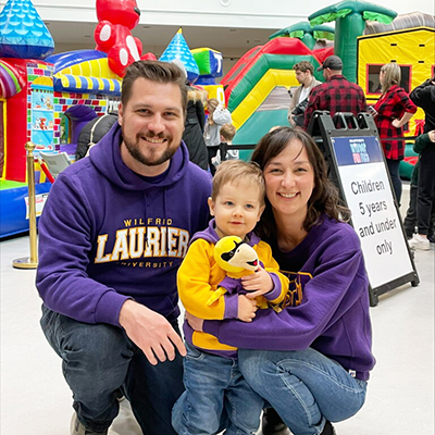A family in front of a bouncy castle