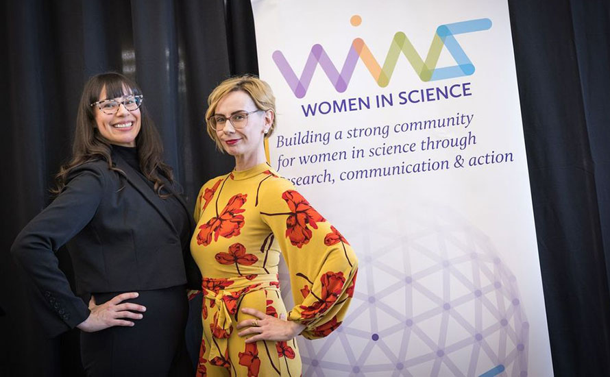 Eden and Skye Hennessey in front of a Laurier Centre for Women in Science sign
