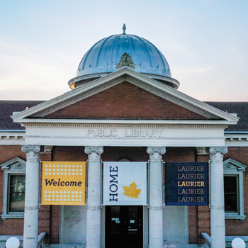 canergie building with welcome home Laurier signs