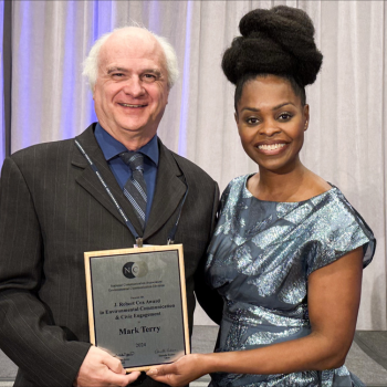 Laurier adjunct professor Mark Terry accepts the J. Robert Cox Award from Marnel Niles Goins, president of the National Communication Association.