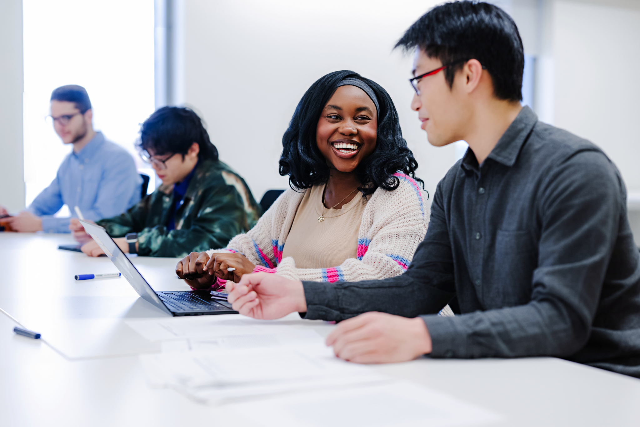 MABE female and male student discussing in class