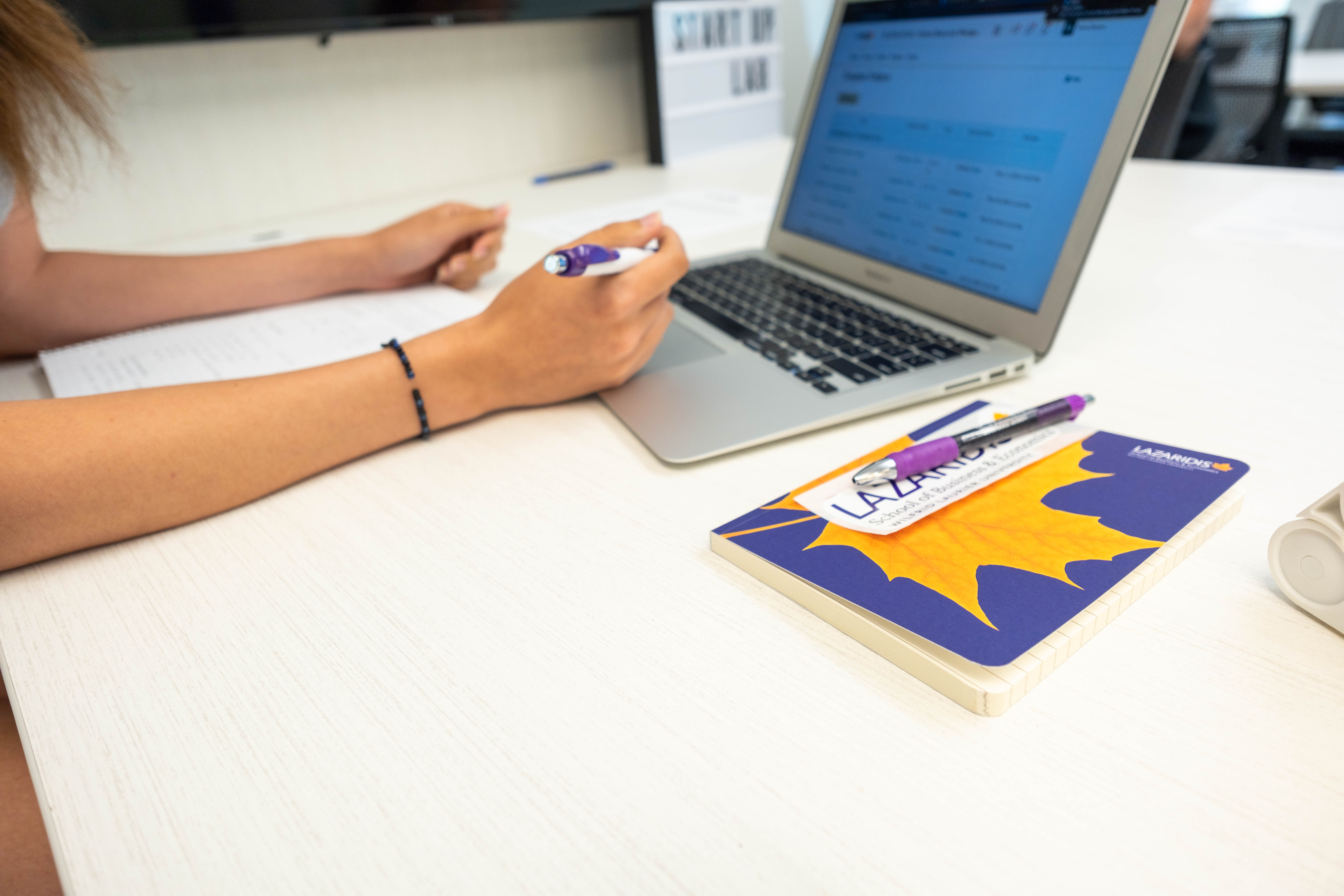 student with laptop and notebook