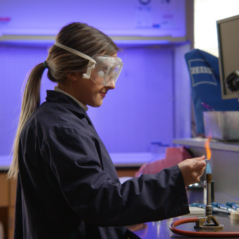 Student working on burner in lab