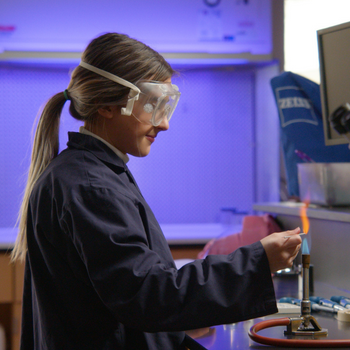 Student using burner in lab