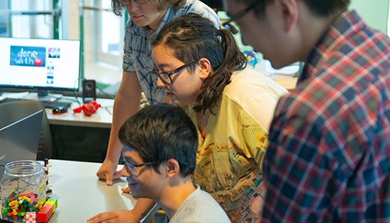 students group around a computer