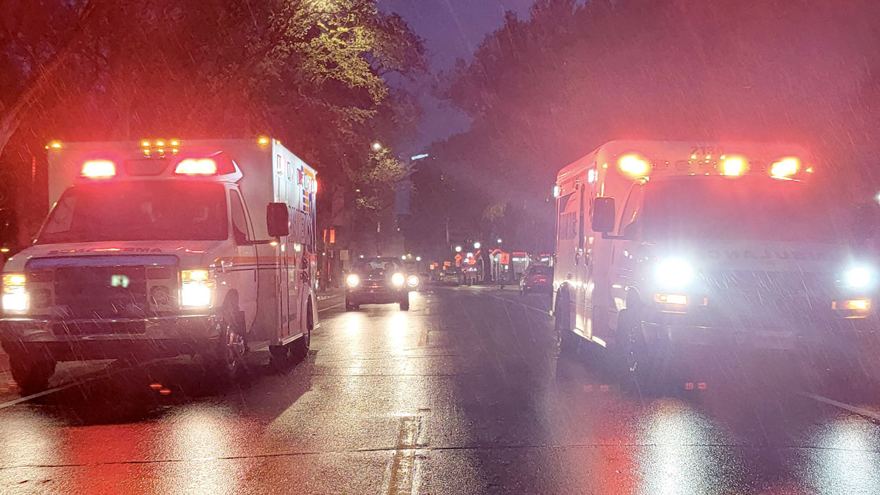 Two paramedic vehicles driving at night